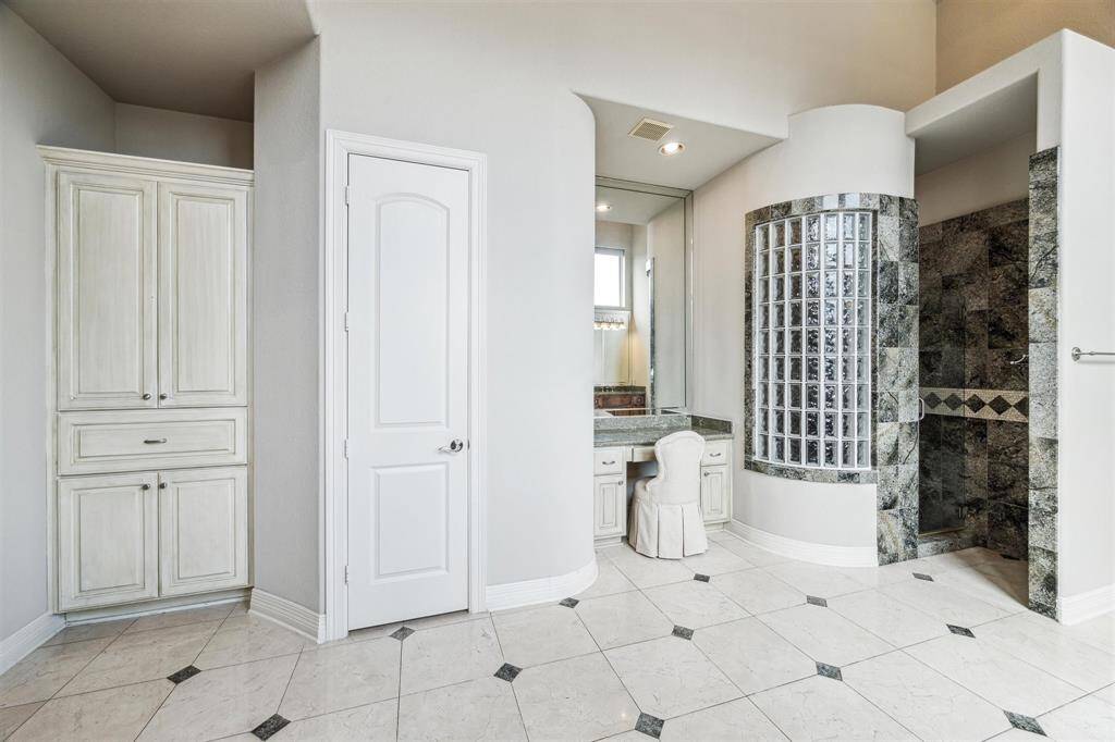 Views of the linen closet, water closet and vanity area