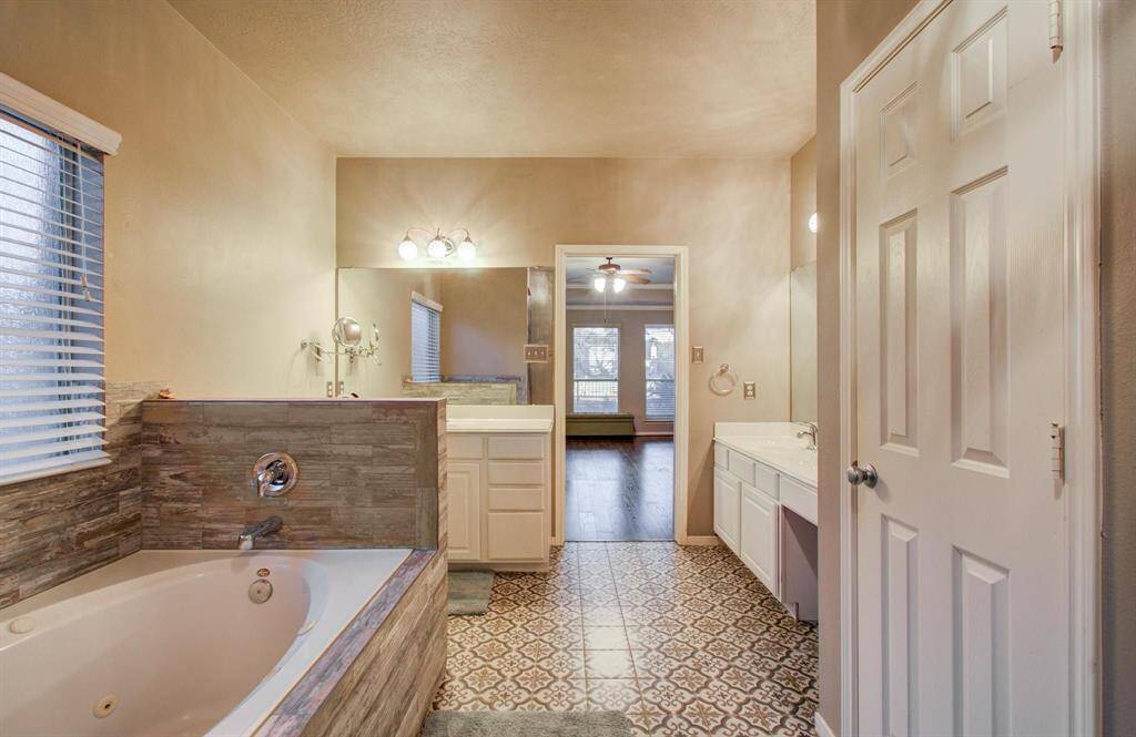 Very nice wide primary bath with split vanities, separate garden soaker tub and shower enclosure