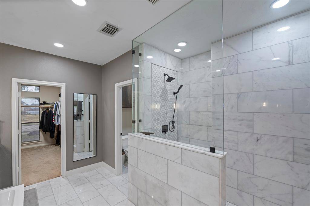 Remodeled primary bathroom with large walk-in shower