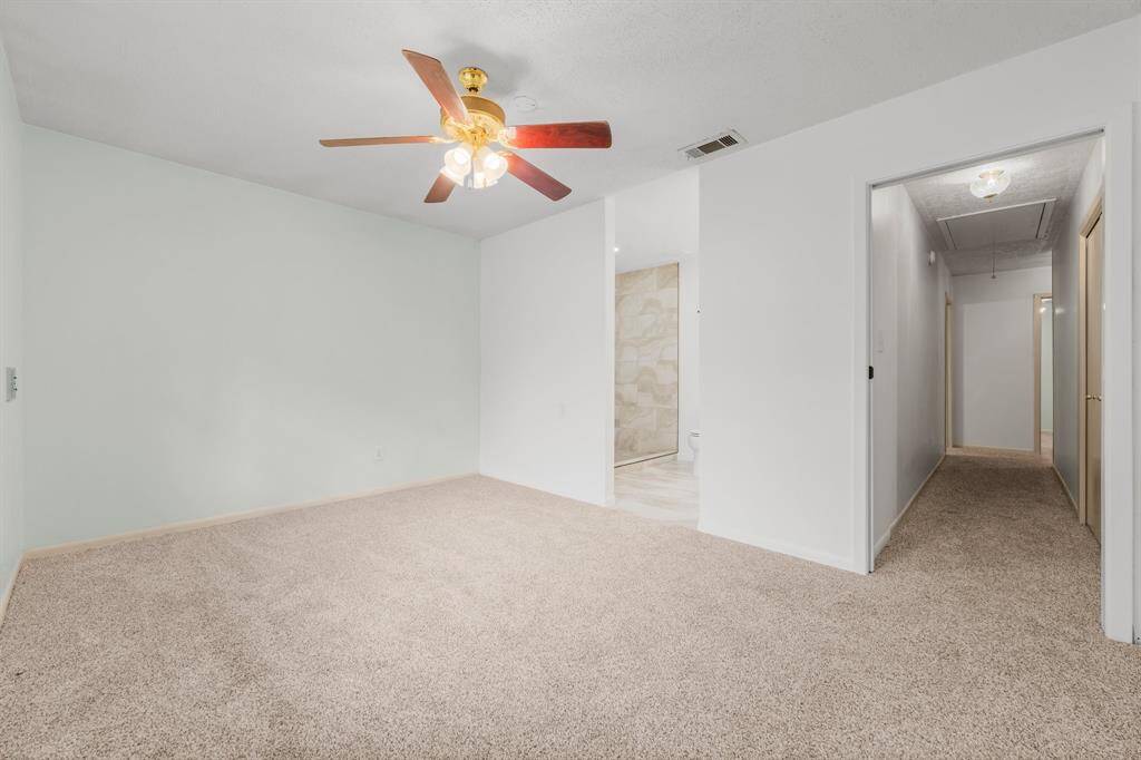 The expanded shower boasts gorgeous tile work and features double shower heads, including a luxurious rain shower head for the ultimate spa-like experience.