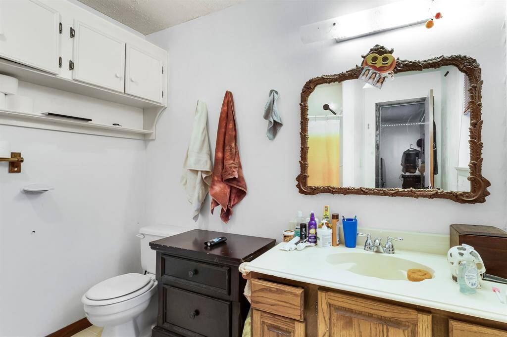 Secondary bathroom offers a functional layout with ample space and essential fixtures for shared use.