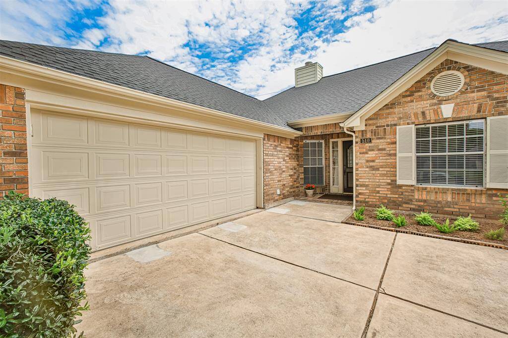 The two-car garage and extra-wide driveway are tucked away from curious neighbors.