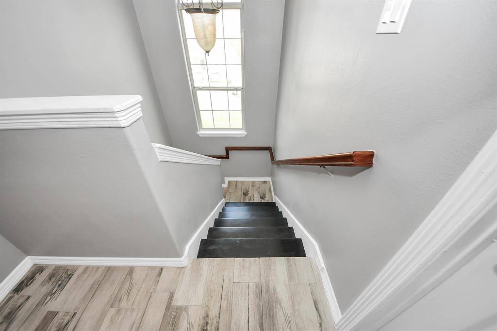 Stairwell has a lovely window to add to the natural light of the home.