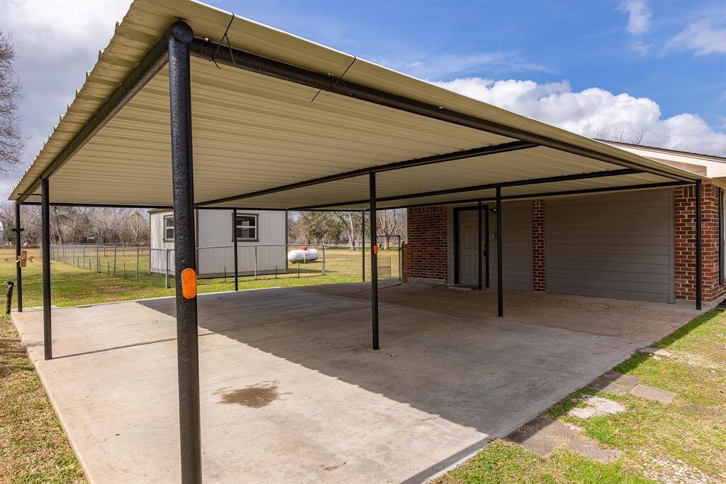 Spacious covered parking for three vehicles.