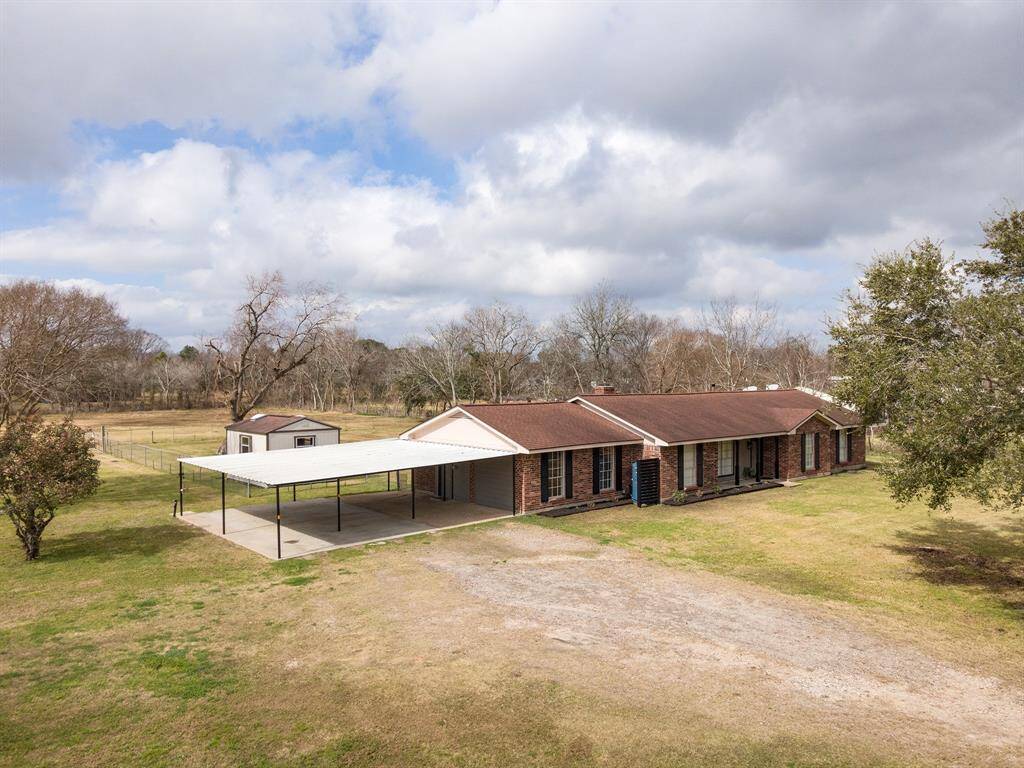 This home features a spacious three-car carport and a fenced backyard, offering both convenience and privacy.