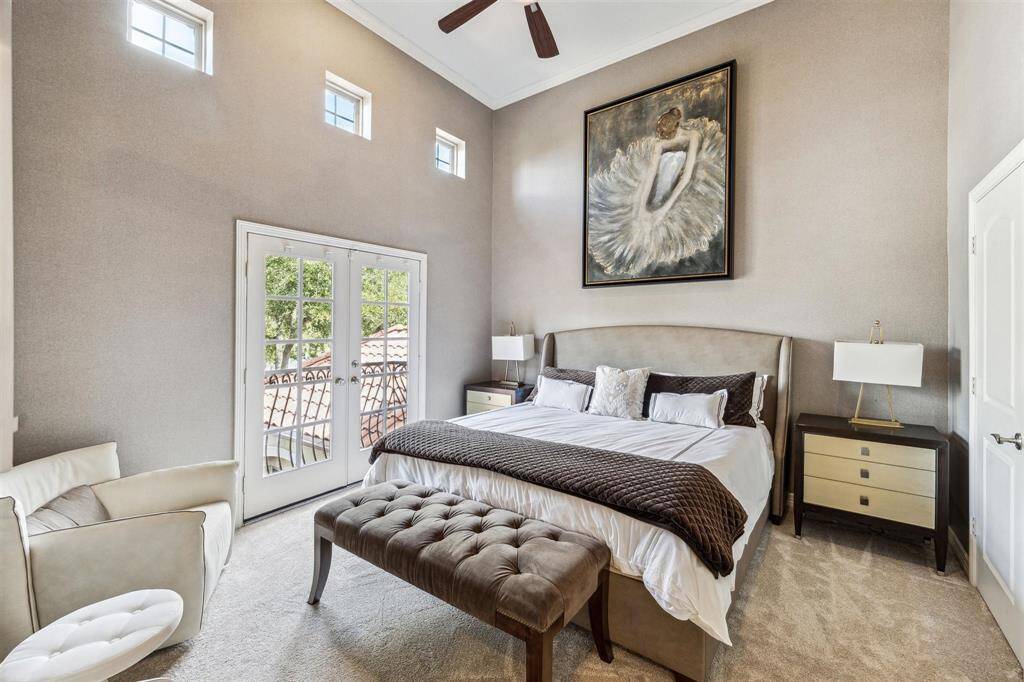 The upstairs front bedroom features extended, high ceilings, walk-in closet and a Juliet balcony