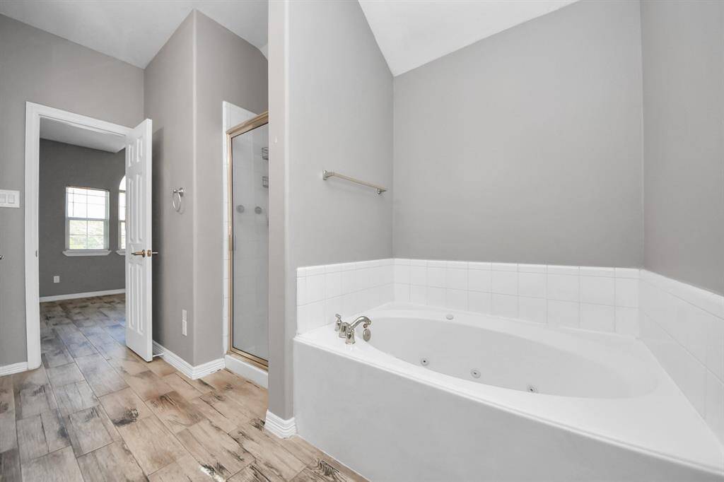 The primary bathroom features double sinks, stylish lighting and framed mirrors for the convenience of the owner(s) of the home.
