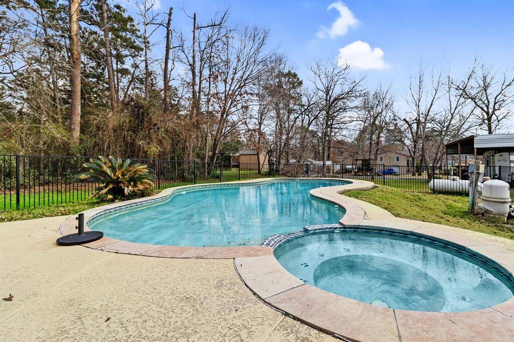 Pool and Hot Tub: Private backyard oasis featuring a pool, hot tub, and recent updates.