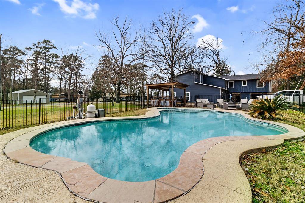 Pool and Hot Tub: Private backyard oasis featuring a pool, hot tub, and recent updates.