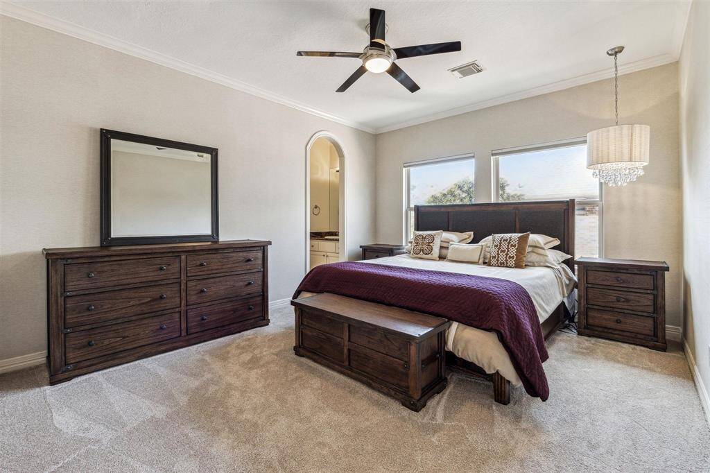 The third upstairs bedroom also has plush carpet and a chandelier