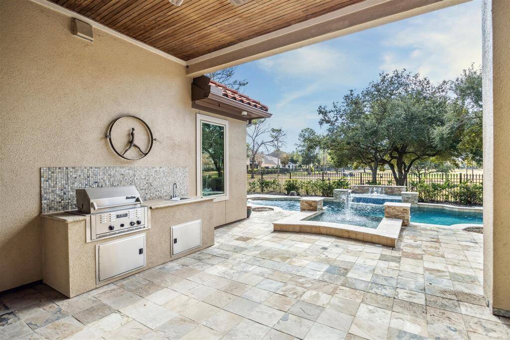 The covered loggia has an outdoor grill and sink area