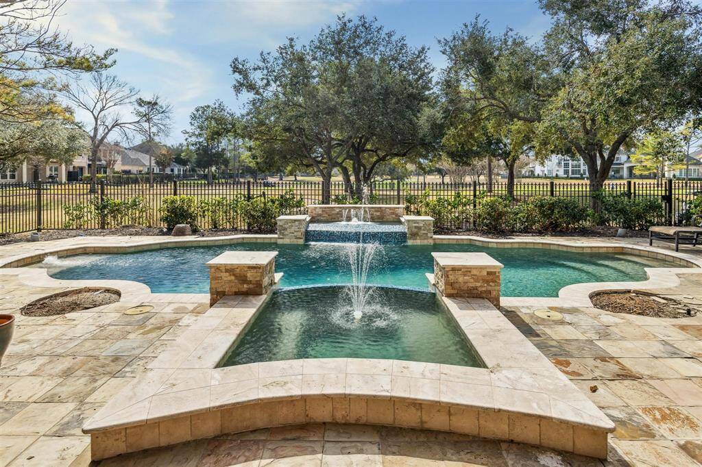 The hot tub and swimming pool have water features and exceptional views