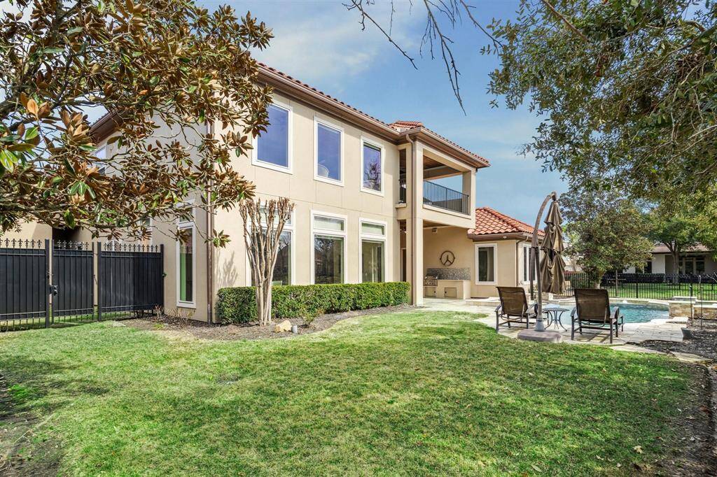 Multiple green spaces and wrought iron fencing