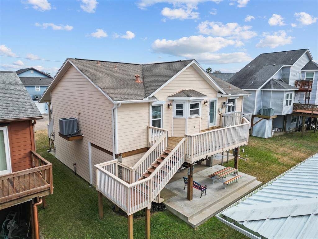 Back deck off the kitchen has stairs down to ground level and cargo lift. This view shows plenty of room for ground level entertaining.