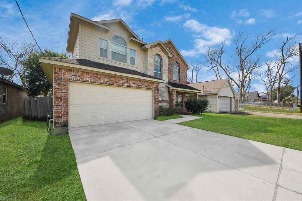 The well-maintained lawn and driveway enhance the curb appeal of this home.