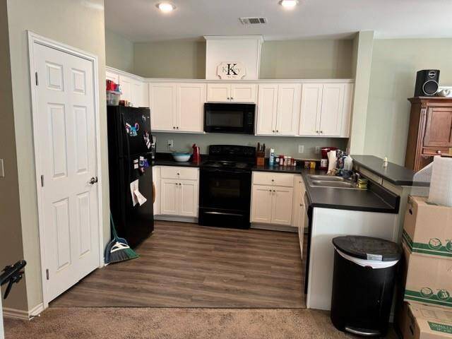Open Kitchen lots of cabinets and full eating bar.