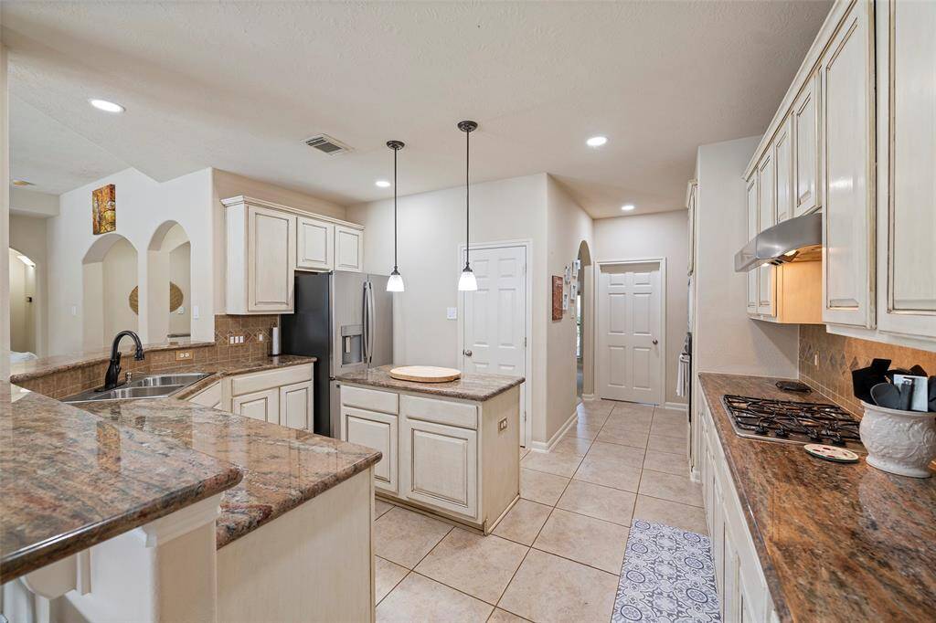 Kitchen open to family living space with easy access to formal dining room.