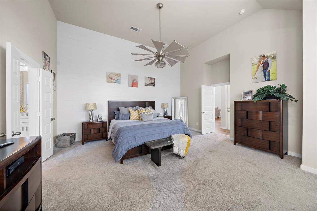 The expansive primary suite includes custom built-in storage, a spacious walk-in closet that conveniently connects to the laundry room, and a spa-like bathroom perfect for unwinding.