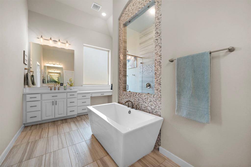 Two sinks, one featuring a spacious vanity area.