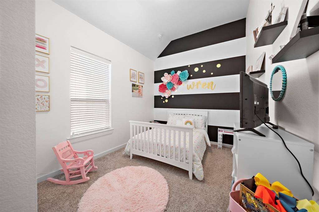 A secondary bedroom featuring a walk-in closet.