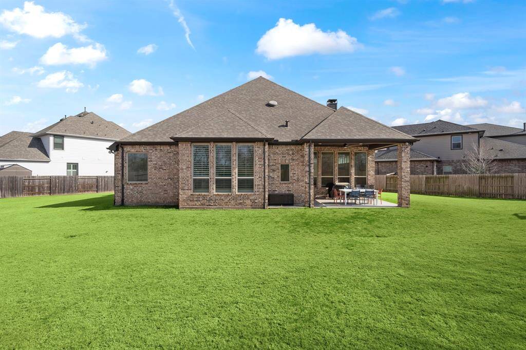 Enjoy the outdoors under the covered patio, with no back neighbors for added privacy.