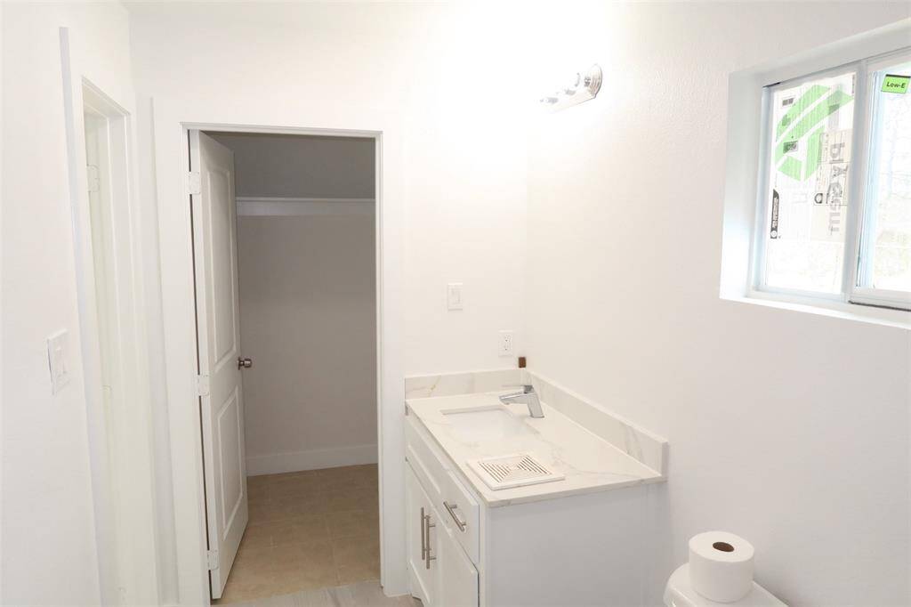 primary bathroom with walk in closet