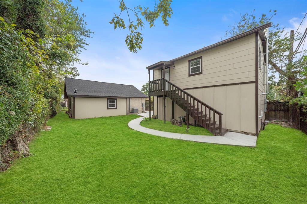 The back yard of the main home and the stairs that take you into the garage apartment.