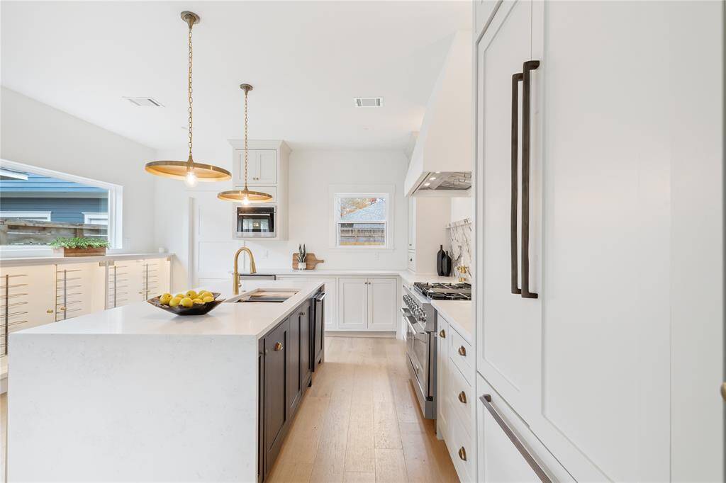 Modern luxury meets classic charm in this beautifully updated kitchen, complete with a spacious island and designer fixtures.