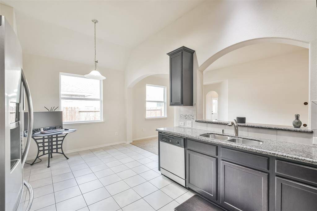 the kitchen is open to the family room and breakfast room