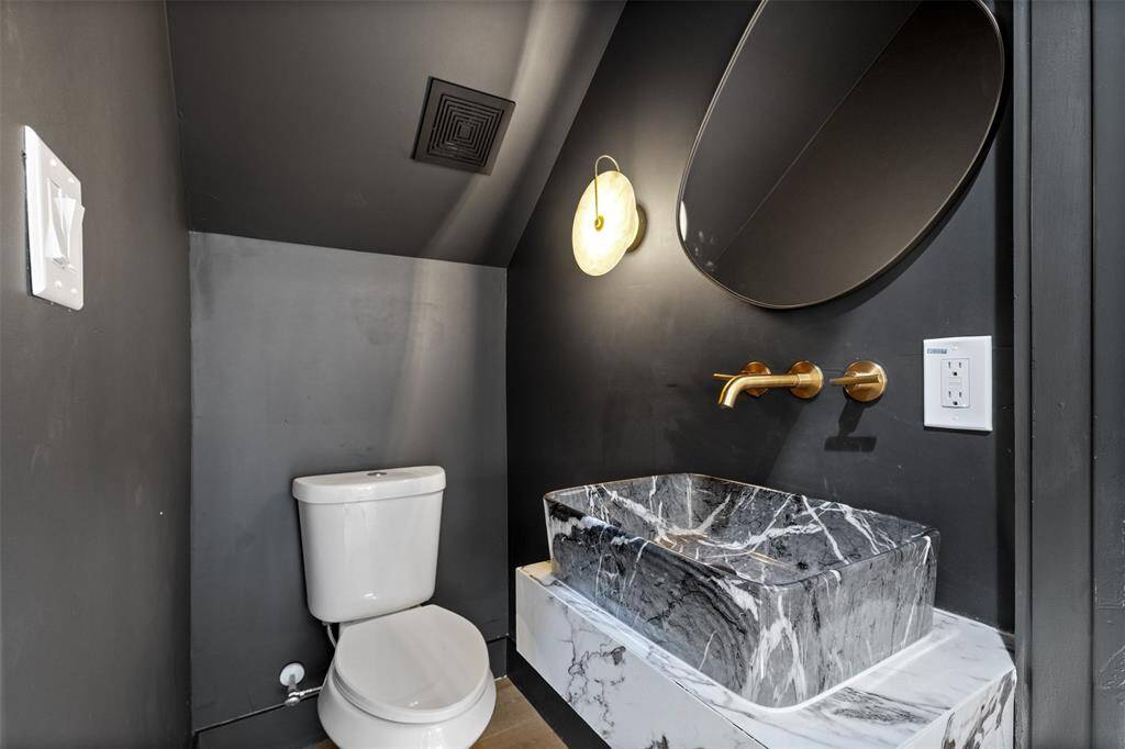 Charming and functional, this half bath blends historic character with modern luxury.