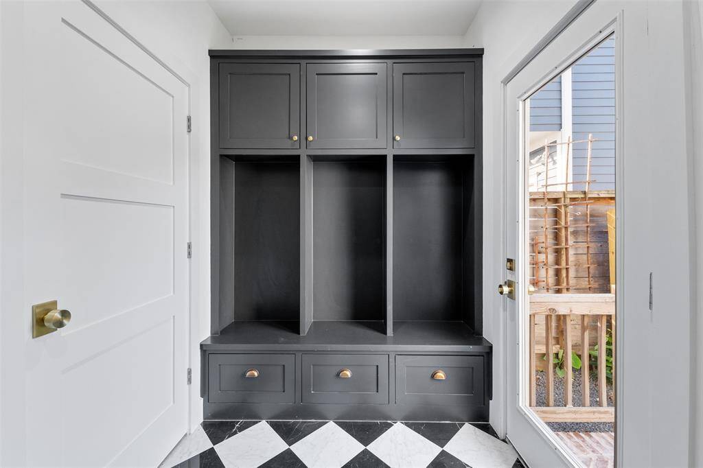 A beautifully designed mudroom with built-in storage, stylish tile flooring, and plenty of space to keep life organized.