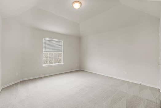 This is a bright bathroom featuring a clean, white tub and shower