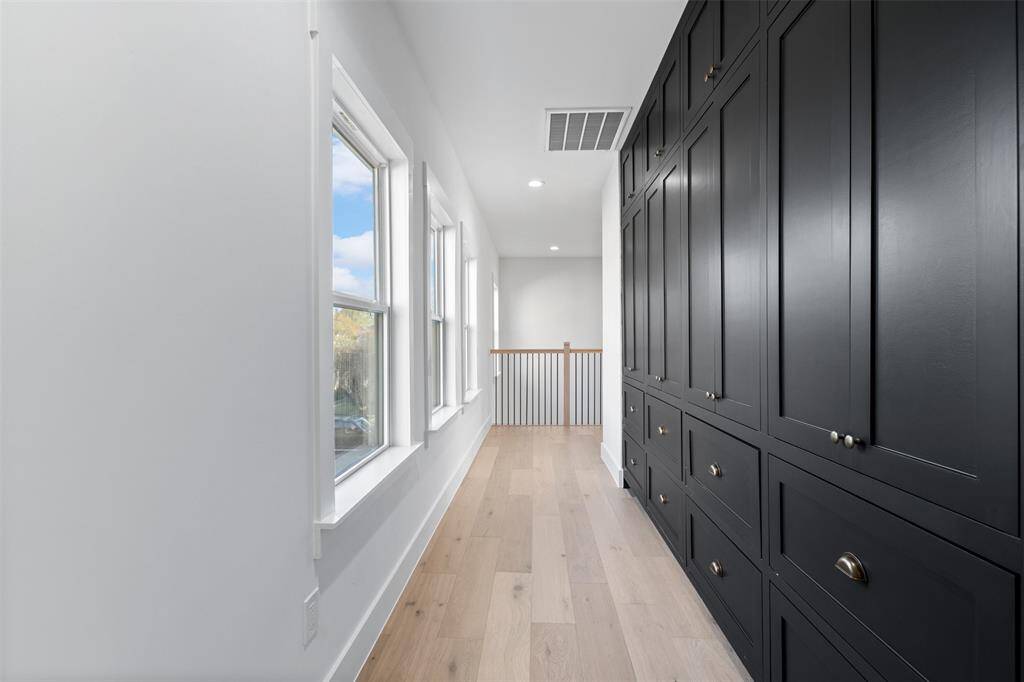 Custom-built storage solutions line this wall, combining elegance with practicality to keep everything perfectly organized without sacrificing style.