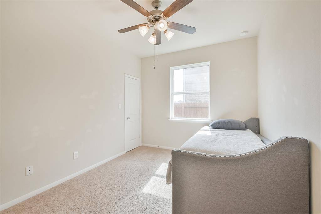 Bedroom #4 features a ceiling fan and an elegant light fixture for added comfort and style.