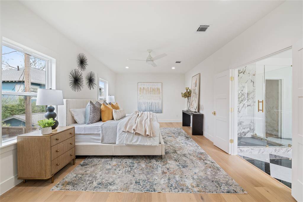 An exquisite primary suite featuring high ceilings, a custom walk-in closet, and a spa-like en suite bath with designer finishes.