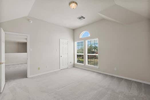 Secondary bedroom with high ceilings and great closet space.