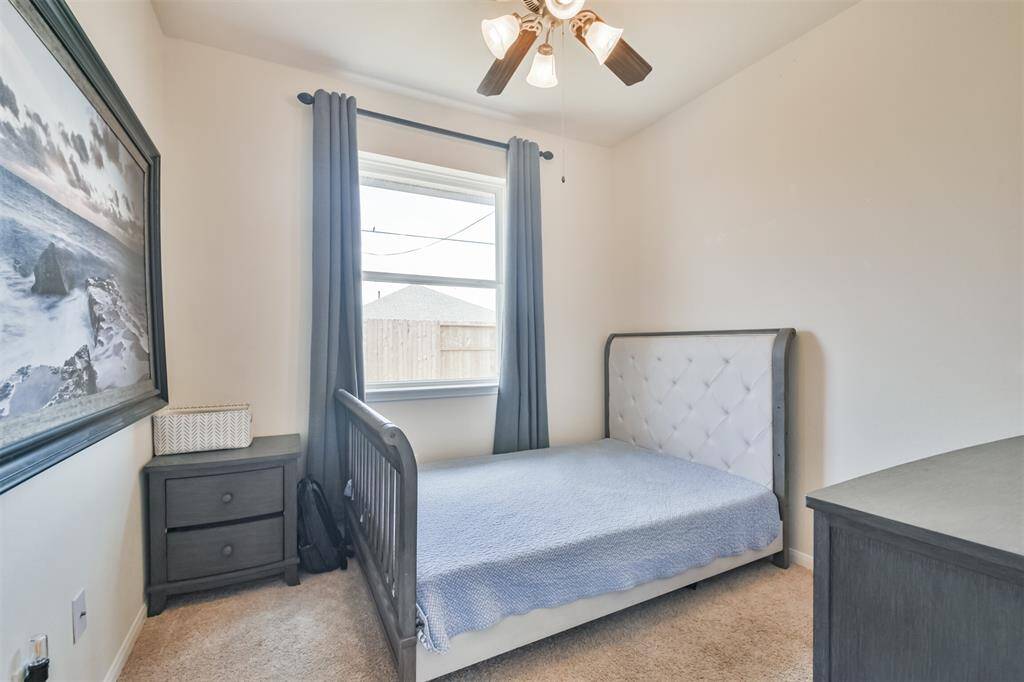Bedroom #2 features a ceiling fan and a stylish light fixture.