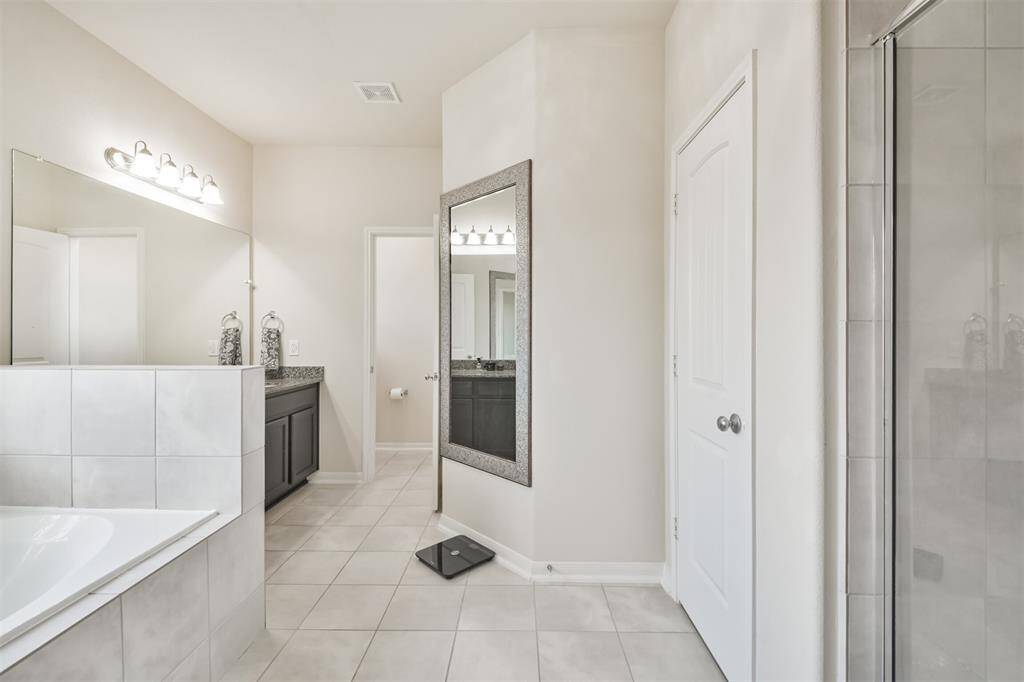 Private bathroom featuring elegant ceramic tile flooring