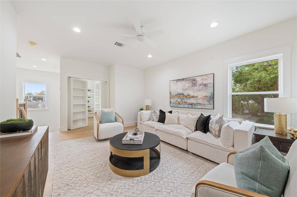 A bright and inviting upstairs bonus living area offers the perfect space for a media room, playroom, or additional lounge—endless possibilities with timeless charm.