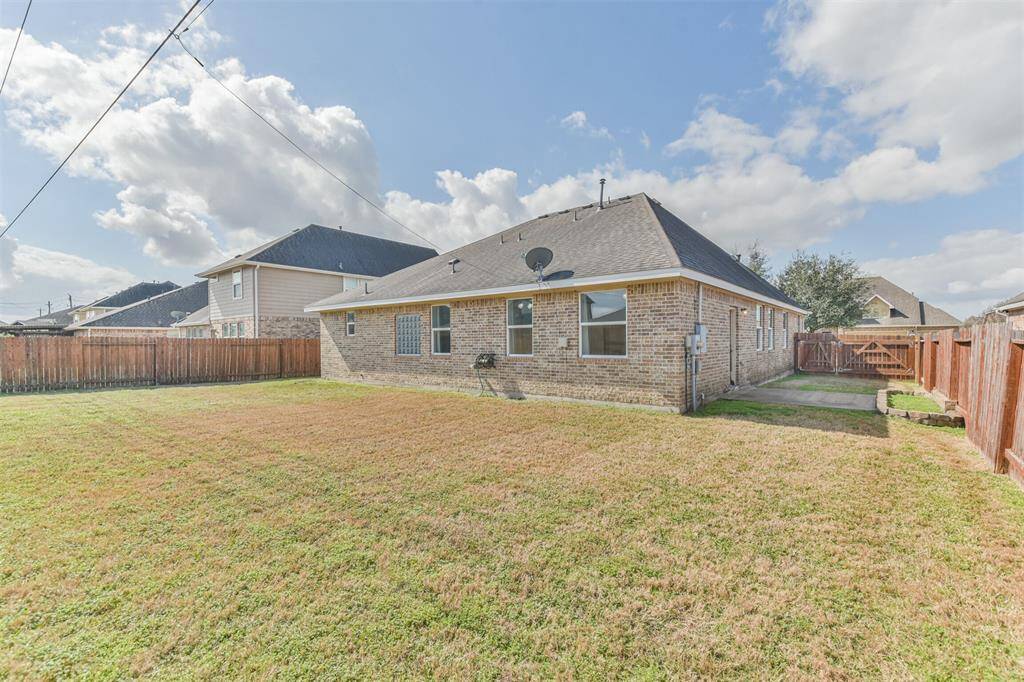Private fenced backyard and durable four-sided brick construction.
