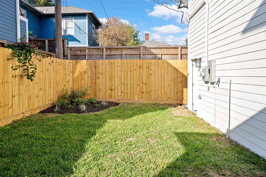 Designed for both beauty and function, this outdoor space features a secure fenced yard and a charming paved patio for effortless outdoor living.