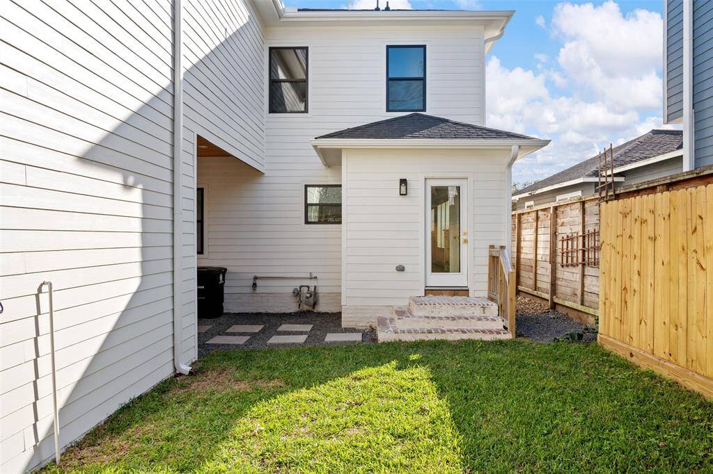 A spacious, fully fenced backyard with a stylish paved patio offers the ideal setting for gatherings, play, or quiet evenings under the stars.