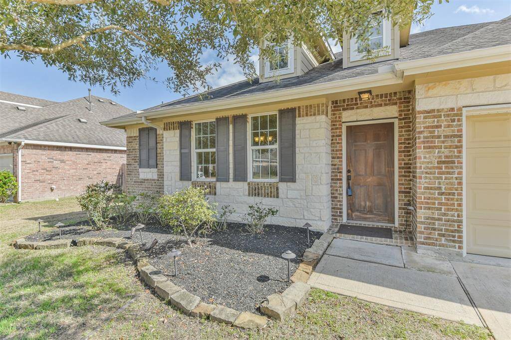 Solar-powered landscape lighting, elegant shutters, and a solid wood front door.