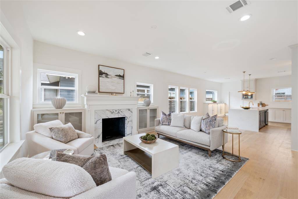 A cozy yet sophisticated living space with custom built-ins, a stunning fireplace, and abundant natural light—perfect for relaxing or entertaining.”