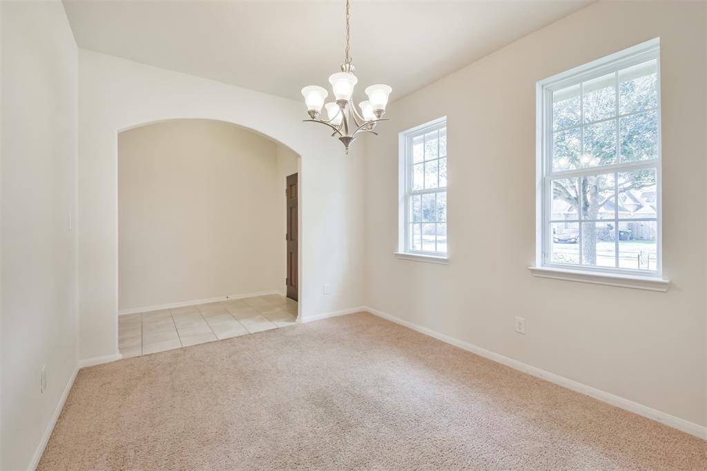 Step into the dining room through a gracefully arched doorway.