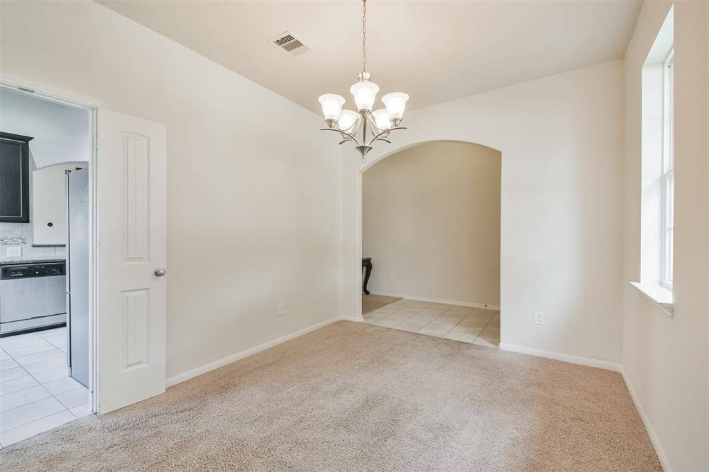 Elegant French doors provide a seamless transition from the dining room to the kitchen.