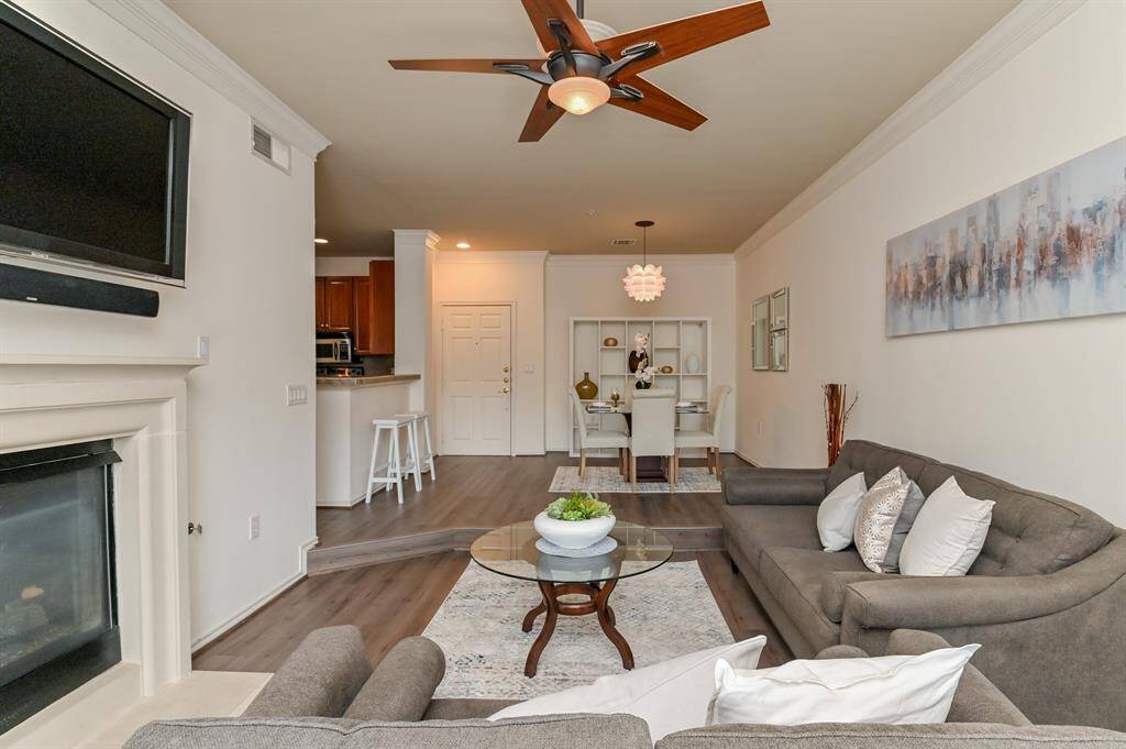Open to the living area, the gourmet kitchen will inspire the chef in you with its stylish and functional design aesthetic featuring wood cabinetry, stylish appliances, and brand new flooring.