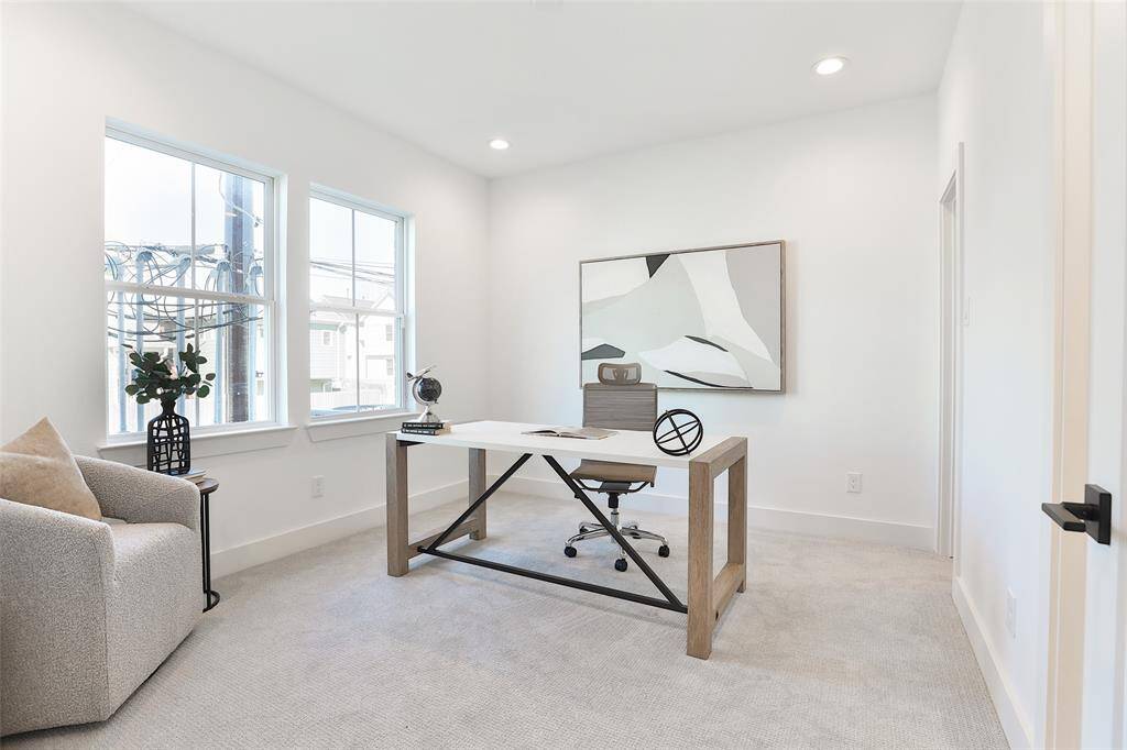 The guest bedroom on the lower level offers direct access to the backyard and a balcony through French doors.