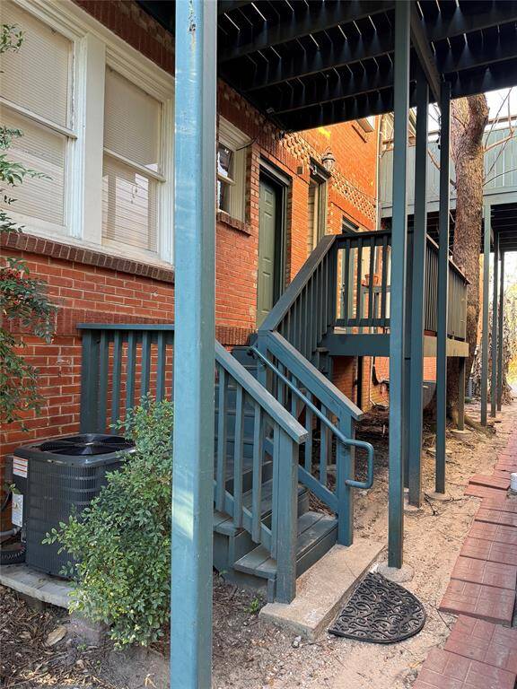 The rear walkway has stair access to the back porch and the new air-conditioning unit at ground level.