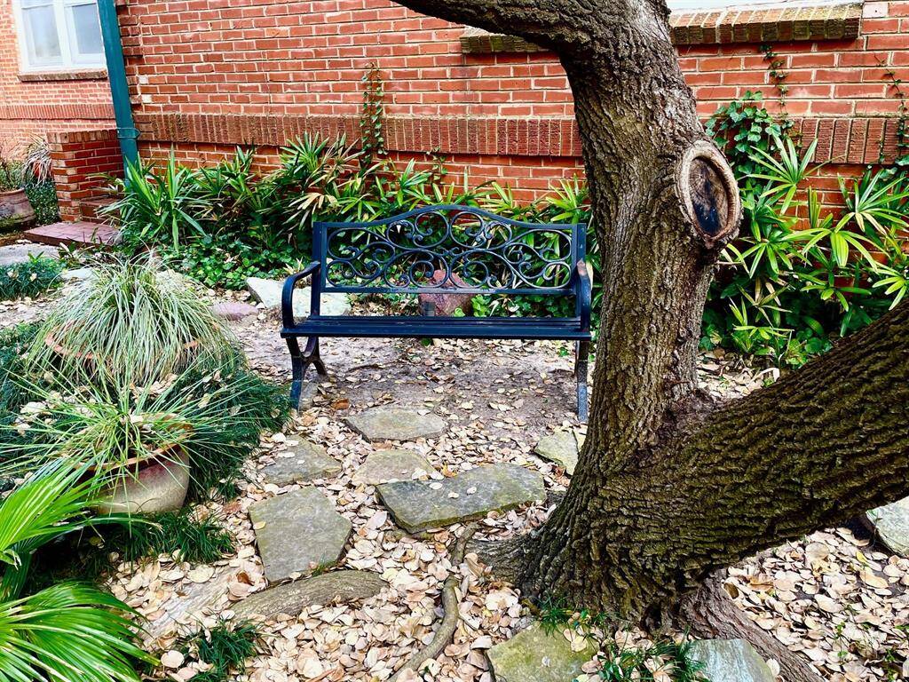 This courtyard bench offers a nice spot to enjoy the shade with a friend or your pet.